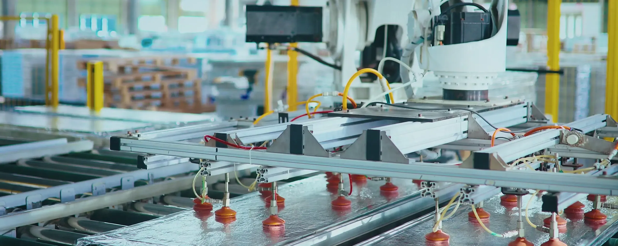 Robotic arm stacking vacuum insulation panels on the automated production line at the Super Tech factory