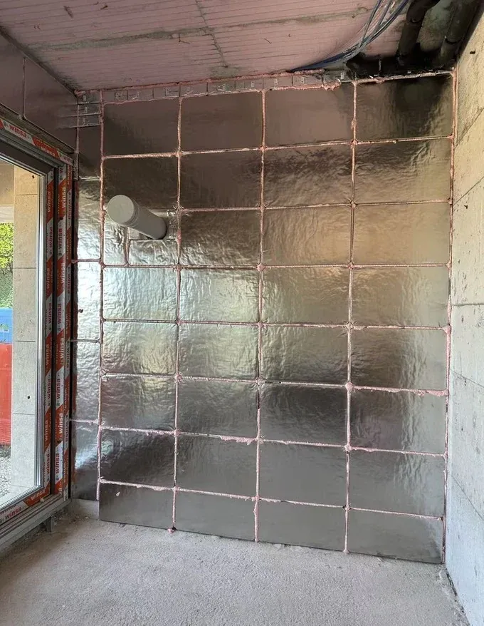 Smaller stainless steel VIP modules arranged around a service pipe opening.